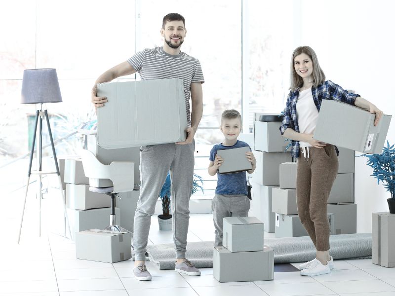 Movers carrying boxes into a new apartment.